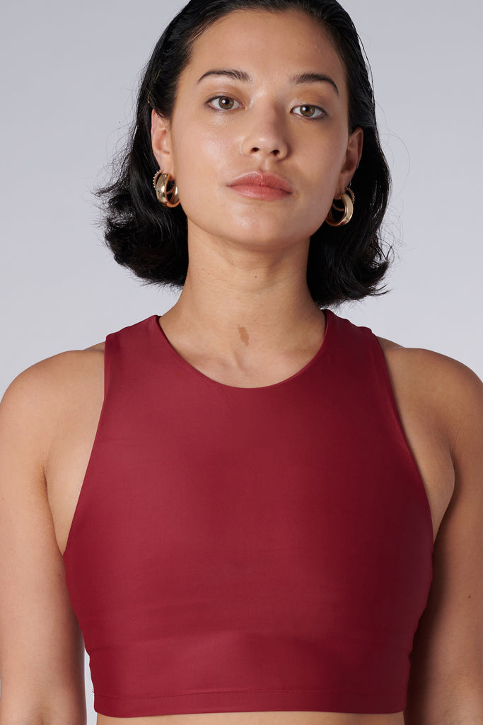 Award-winning wine red crop top with a flattering cut, high neckline for coverage, and in-built sports bra. Medium impact support, perfect for day wear, close up