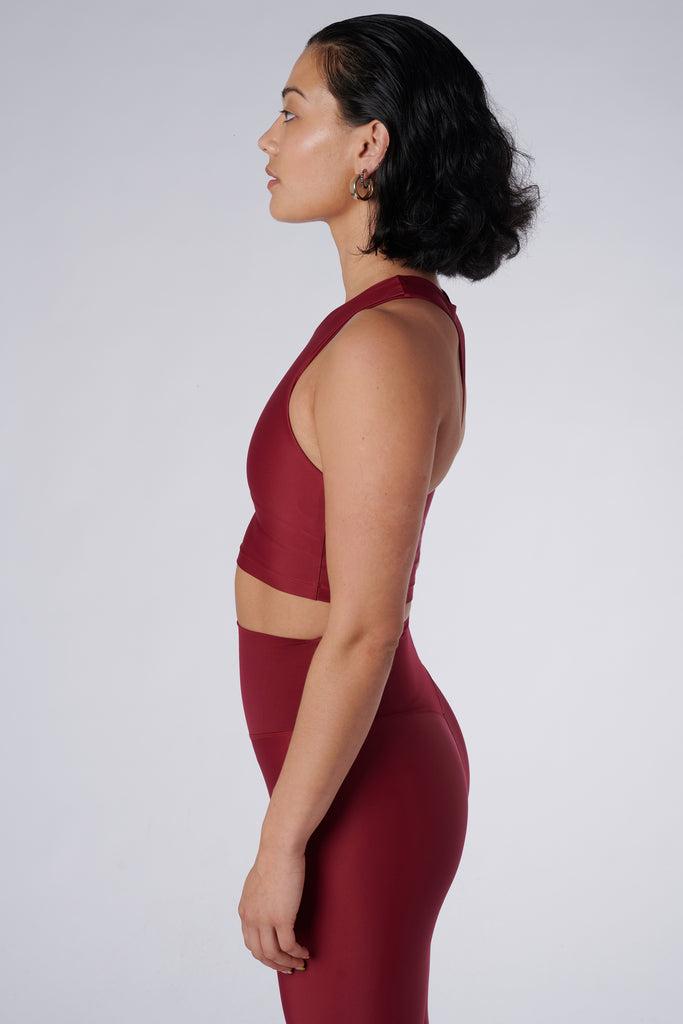 Award-winning wine red crop top with a flattering cut, high neckline for coverage, and in-built sports bra. Medium impact support, perfect for day wear, side view