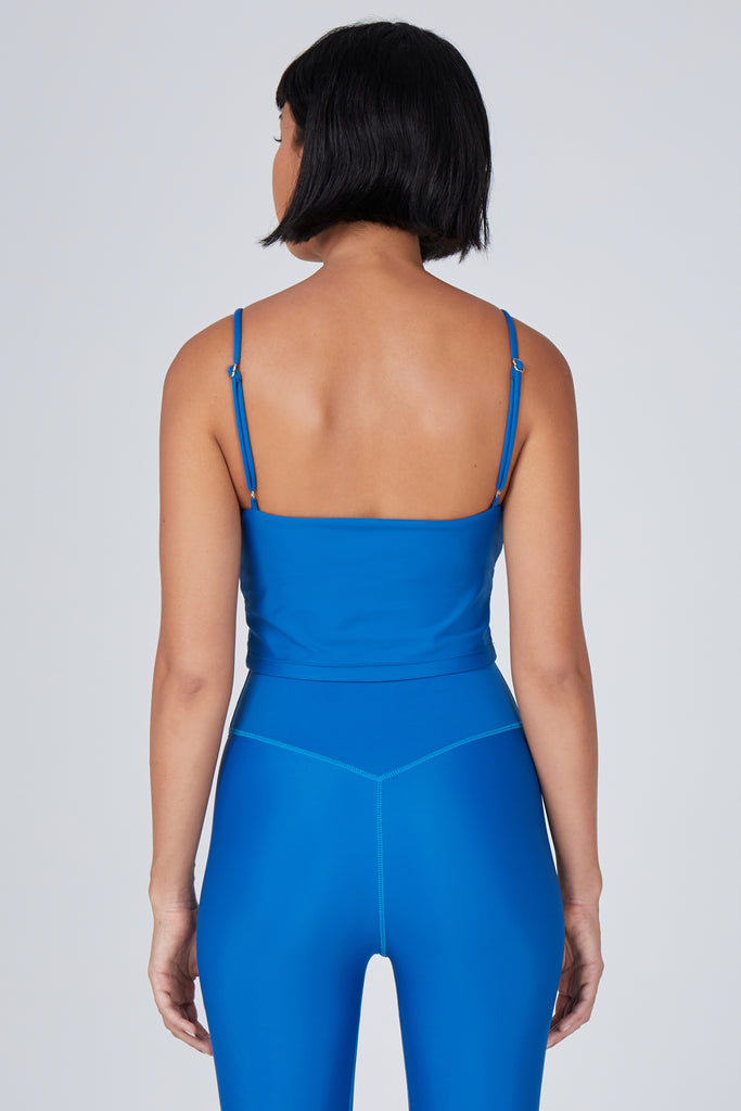 Mid blue crop top with inbuilt bra for low-impact activities, seamless fit, removable padding, and adjustable straps. Comfortable for work or on the go, back view