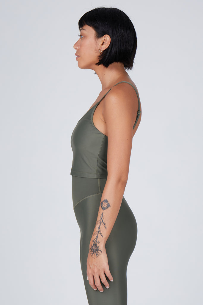 Olive green crop top with inbuilt bra for low-impact activities, seamless fit, removable padding, and adjustable straps. Comfortable for work or on the go, side view